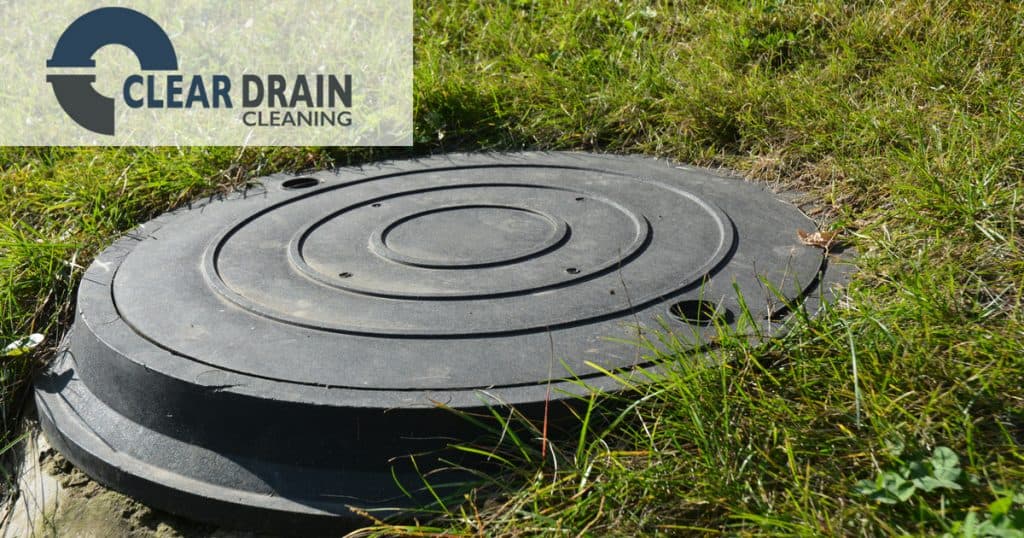 Image of a septic cover at ground level in a grassy yard