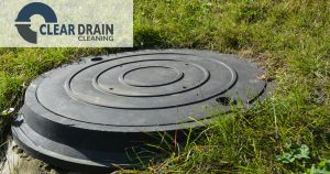 Image of a septic cover at ground level in a grassy yard